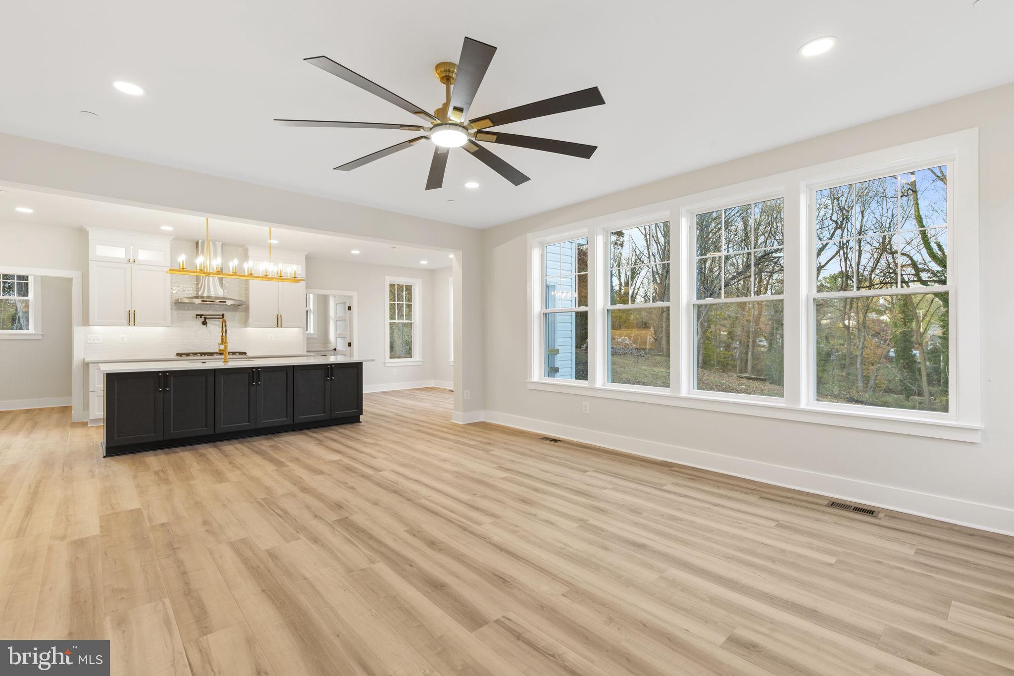 1108 Litchfield Road Baltimore, MD 21239 - Photo 4 of 109 a view of an empty room with wooden floor and a window
