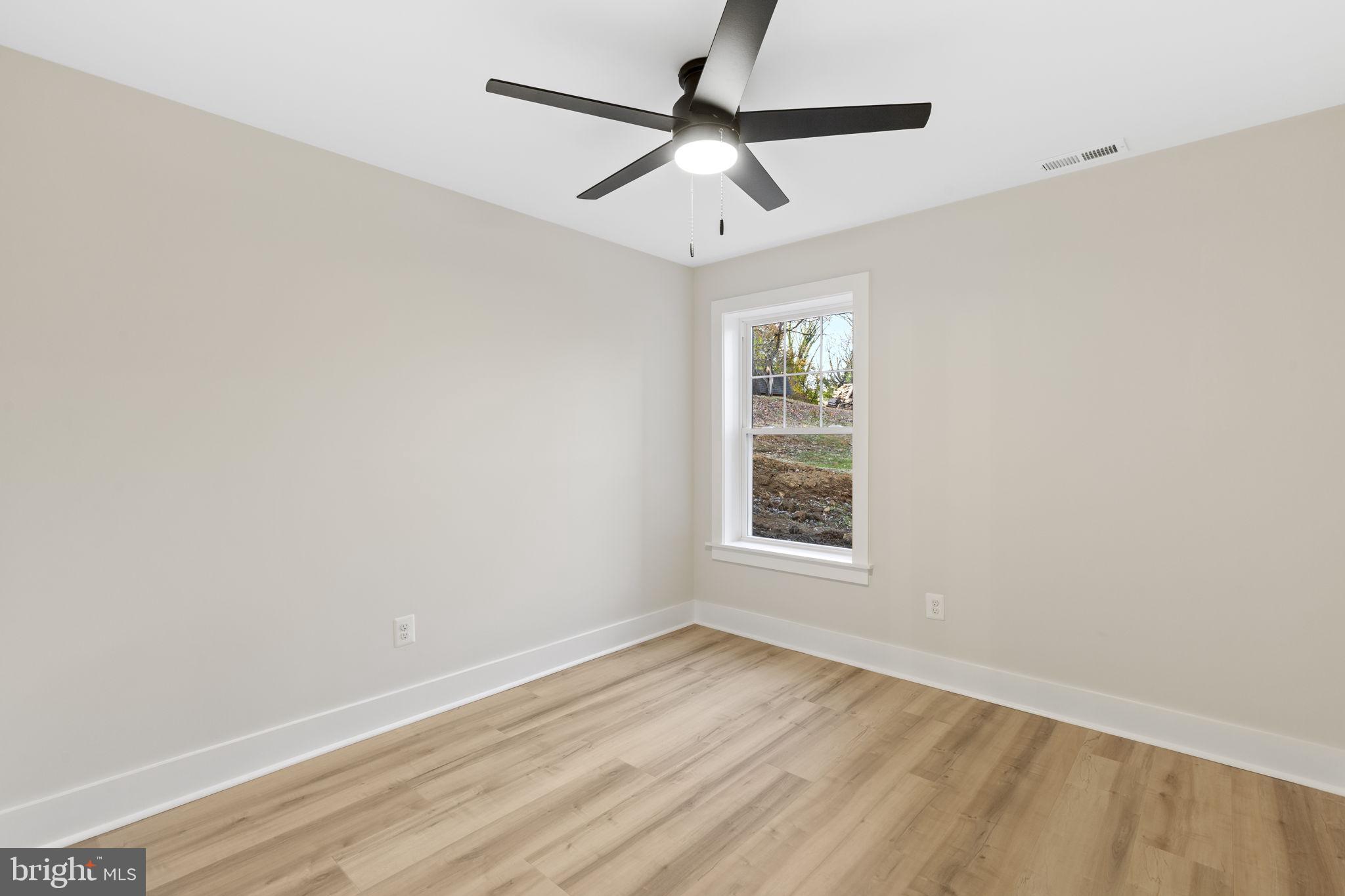 1108 Litchfield Road Baltimore, MD 21239 - Photo 44 of 109 an empty room with a window and a ceiling fan