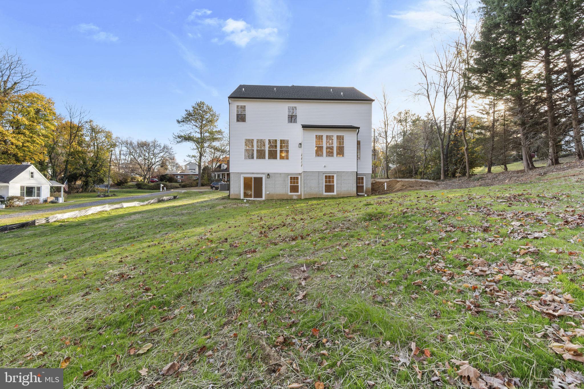 1108 Litchfield Road Baltimore, MD 21239 - Photo 47 of 109 a view of a house with a big yard and large trees