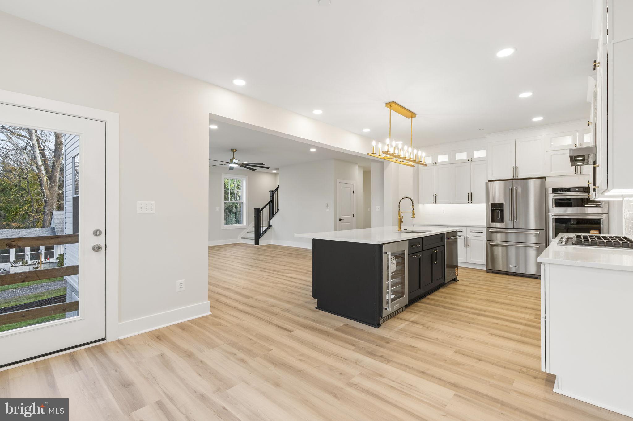 1108 Litchfield Road Baltimore, MD 21239 - Photo 8 of 109 a large kitchen with stainless steel appliances kitchen island granite countertop a large counter top and a stove top oven