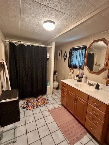 a spacious bathroom with a sink and a mirror