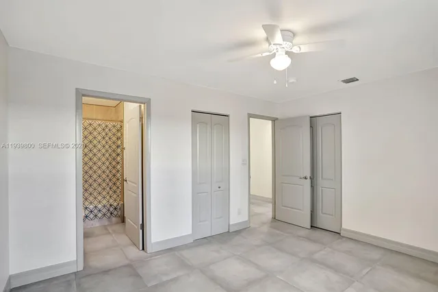 a view of an empty room with a fan