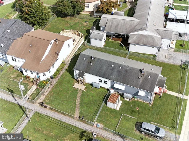 an aerial view of a house with a yard basket ball court and outdoor seating