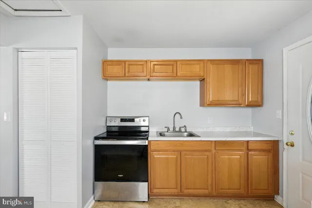 a kitchen with granite countertop a sink and a stove top oven