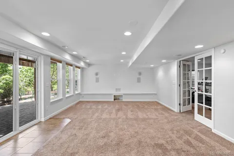 a view of big room with wooden floor and windows