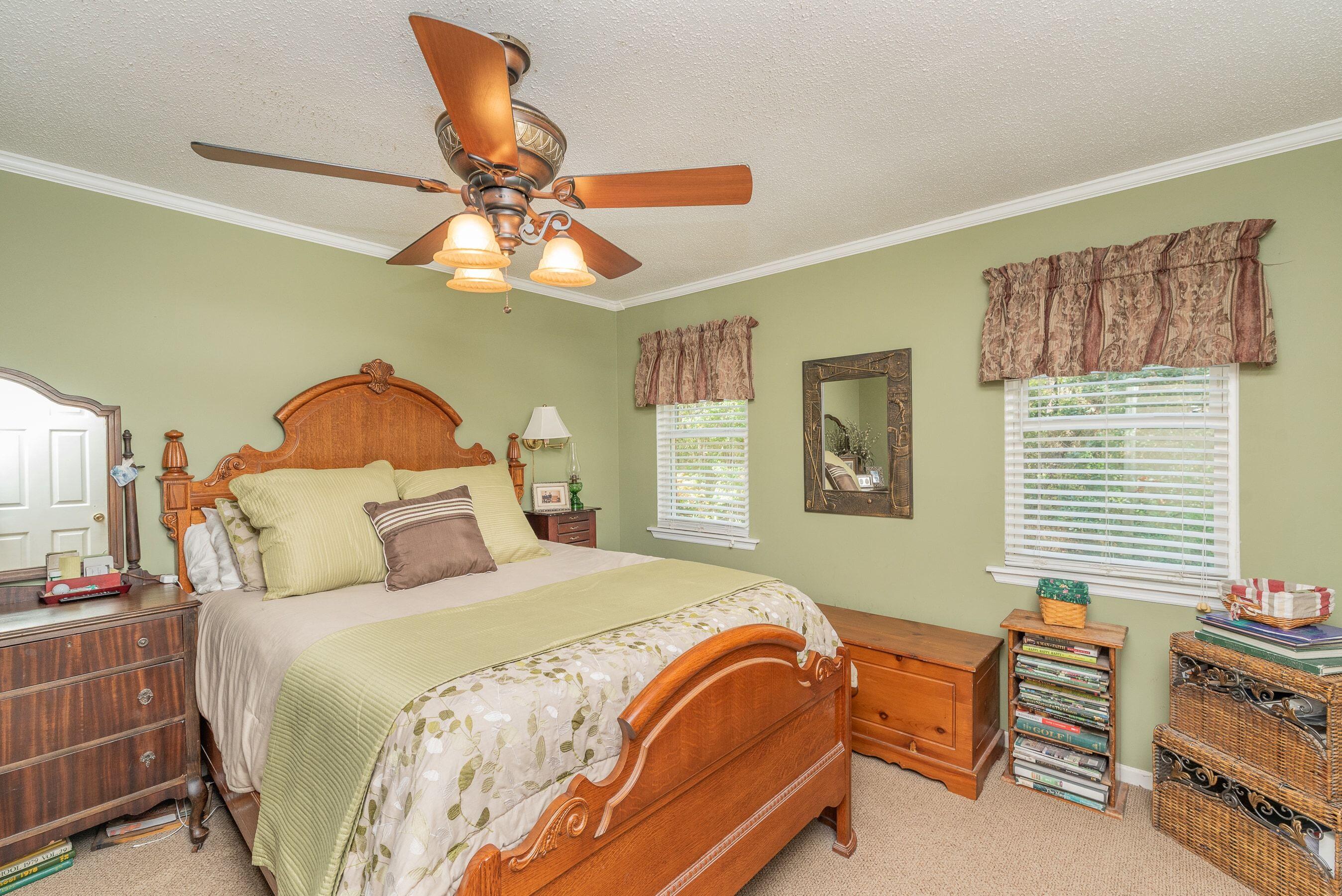 1117 Ridgemont Drive Aiken, SC 29803 - Photo 29 of 49 a bedroom with a bed and a chandelier