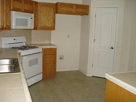 7553 Pit Road Redding, CA 96001 - Photo 5 of 12 a kitchen with white cabinets and white appliances