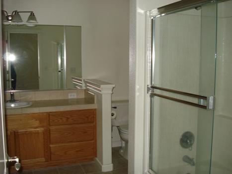 7553 Pit Road Redding, CA 96001 - Photo 10 of 12 a bathroom with a shower sink and mirror