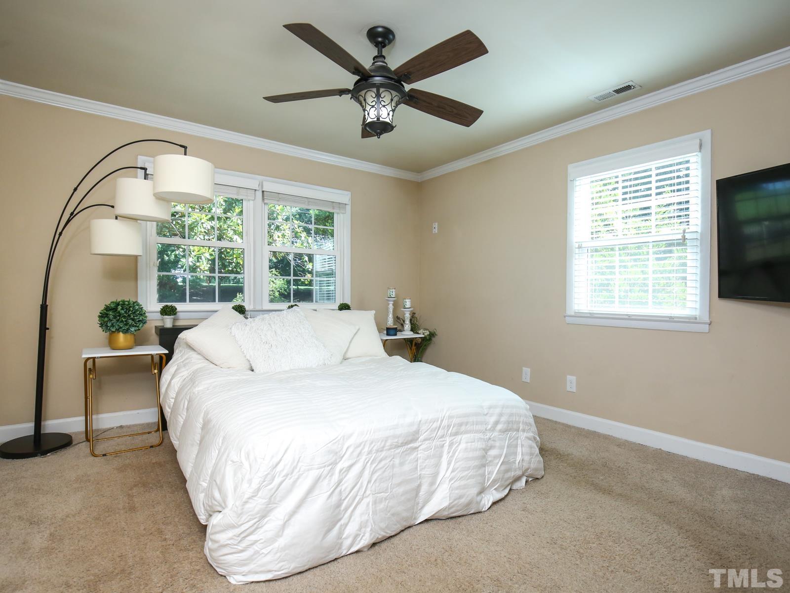 6013 Trinity Drive Raleigh, NC 27607 - Photo 14 of 30 a large bed sitting in a bedroom next to a window