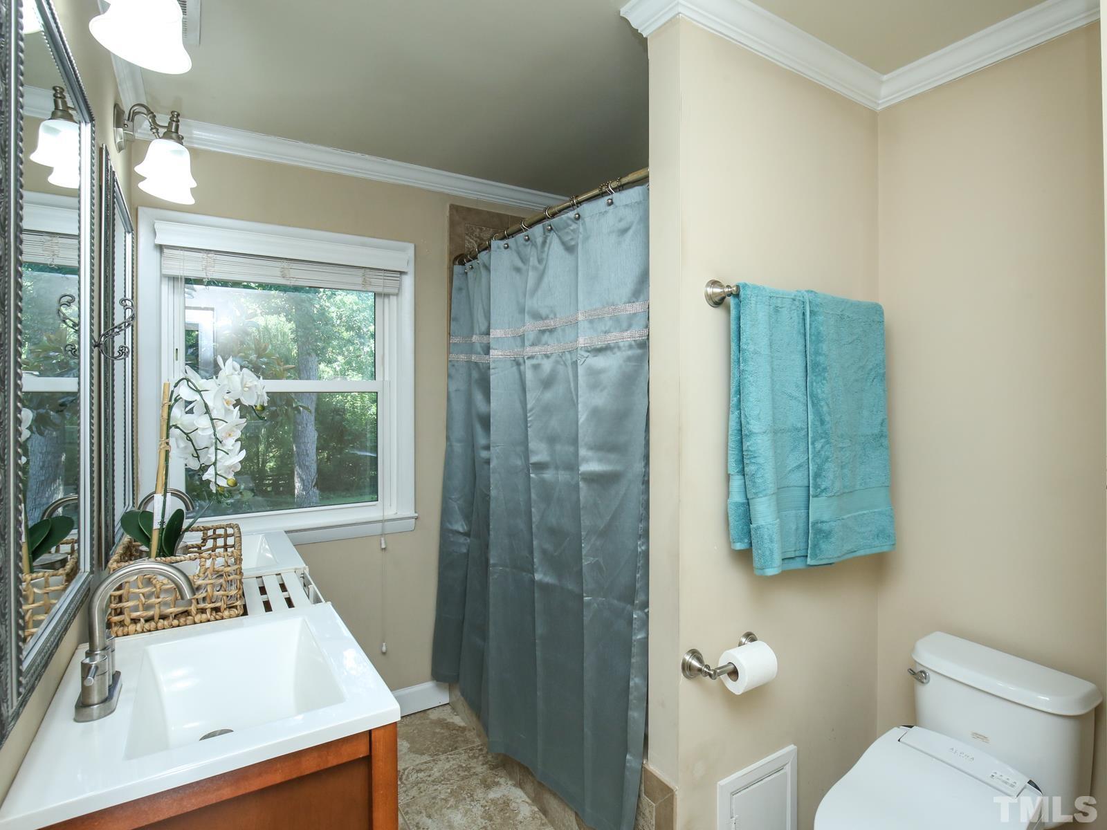 6013 Trinity Drive Raleigh, NC 27607 - Photo 15 of 30 a bathroom with a sink a toilet and shower