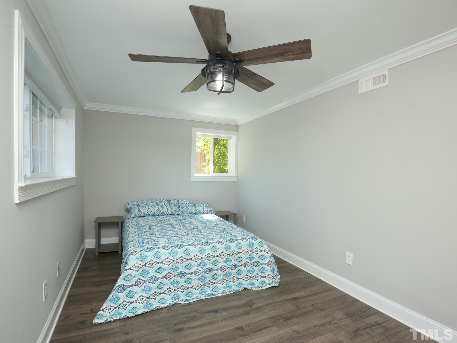 6013 Trinity Drive Raleigh, NC 27607 - Photo 17 of 30 a bedroom with a bed and window