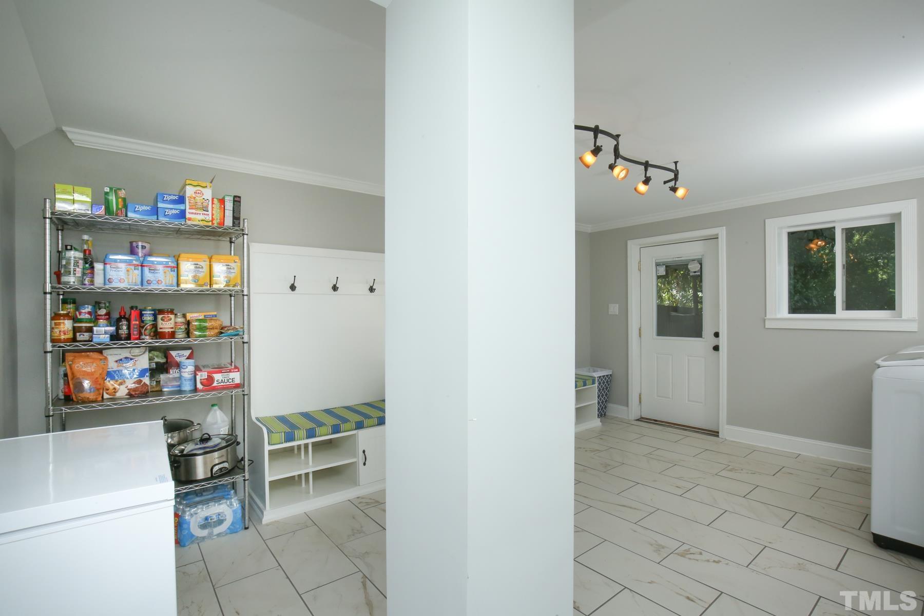 6013 Trinity Drive Raleigh, NC 27607 - Photo 18 of 30 a room with furniture a rug and a window