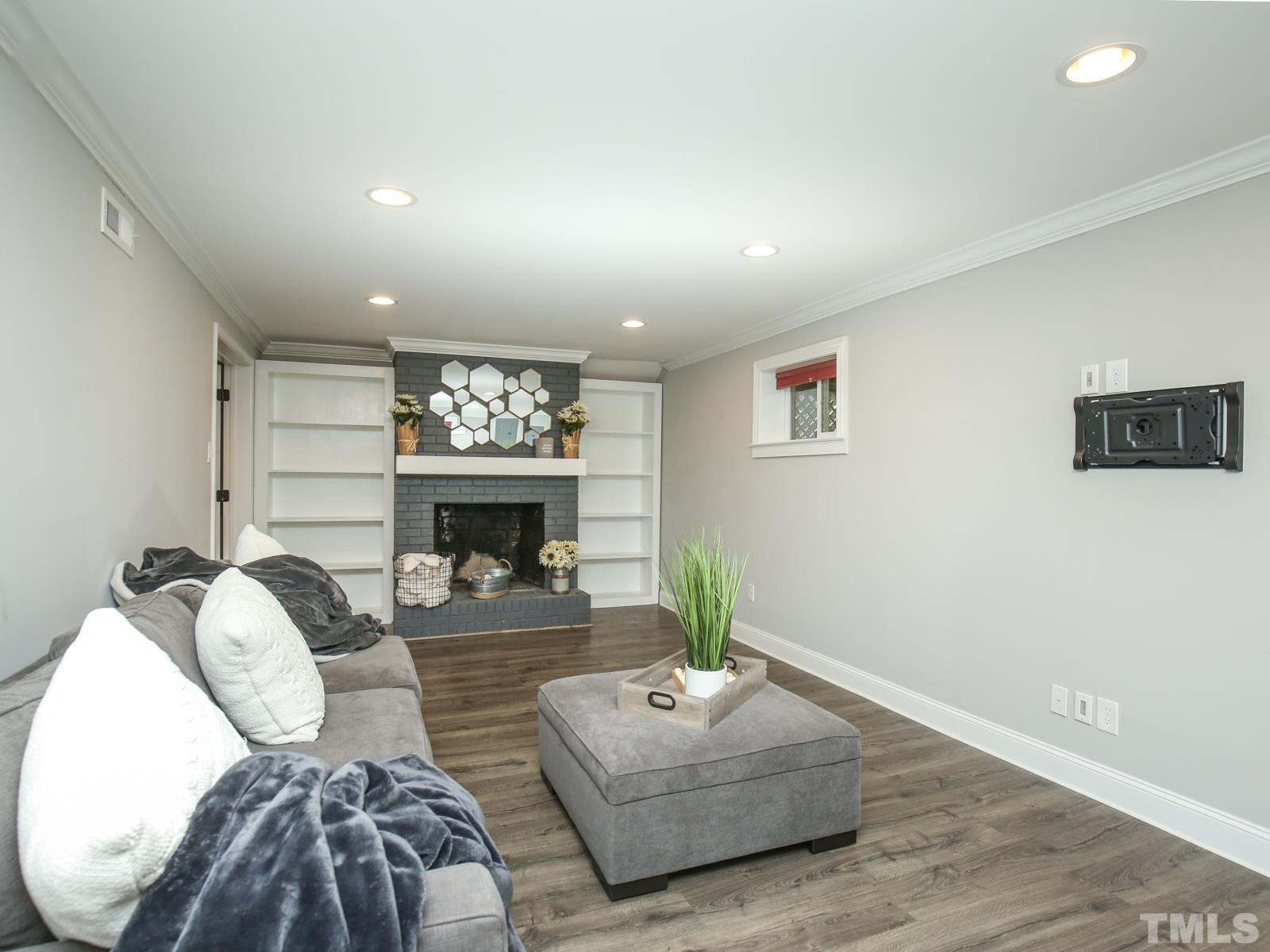 6013 Trinity Drive Raleigh, NC 27607 - Photo 22 of 30 a living room with furniture and a fireplace