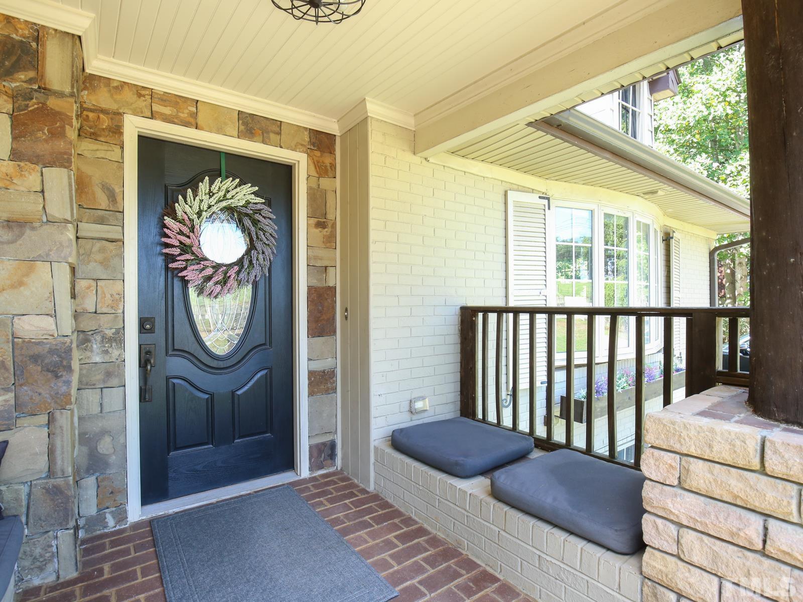6013 Trinity Drive Raleigh, NC 27607 - Photo 5 of 30 a view of a hallway with wooden floor and a potted plant