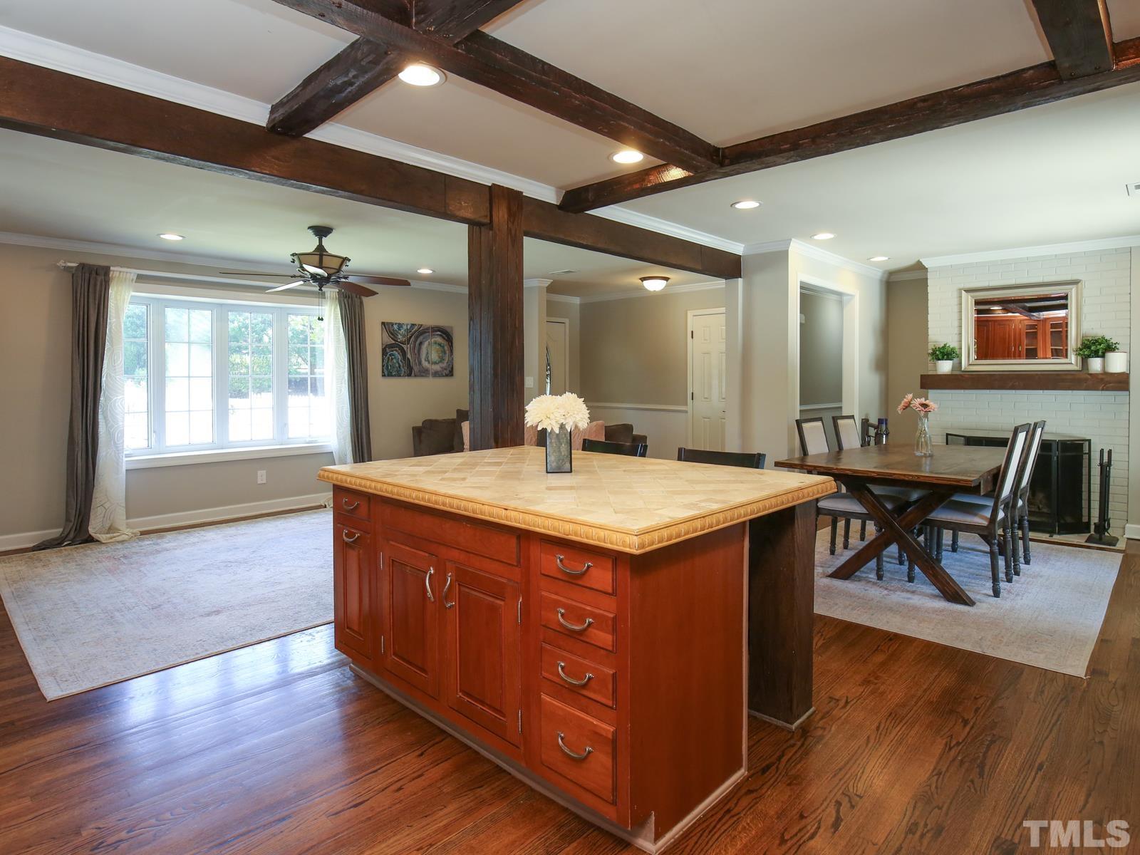 6013 Trinity Drive Raleigh, NC 27607 - Photo 9 of 30 a large kitchen with kitchen island granite countertop wooden floors and a large window