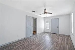 wooden floor in an empty room with a window