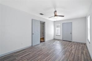 1616 North Pecos Street Lockhart, TX 78644 - Photo 12 of 27 wooden floor in an empty room with a window