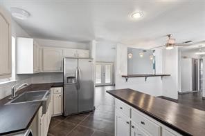 1616 North Pecos Street Lockhart, TX 78644 - Photo 14 of 27 a kitchen with stainless steel appliances granite countertop a sink refrigerator and cabinets