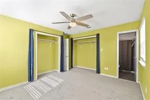 a view of a hallway with a ceiling fan