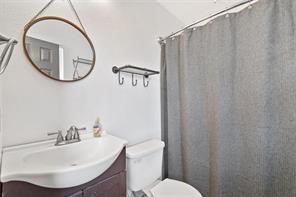 1616 North Pecos Street Lockhart, TX 78644 - Photo 16 of 27 a bathroom with a sink and a mirror
