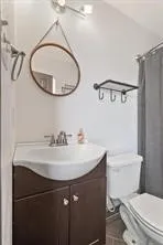 a bathroom with a sink a mirror a toilet and a mirror