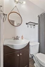 1616 North Pecos Street Lockhart, TX 78644 - Photo 17 of 27 a bathroom with a sink a mirror a toilet and a mirror