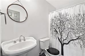 1616 North Pecos Street Lockhart, TX 78644 - Photo 20 of 27 a bathroom with a toilet and a sink