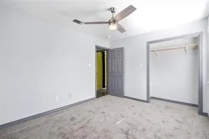 an empty room with fan and a ceiling fan