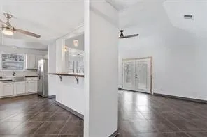 a view of a kitchen with a white cabinet and a stove top oven
