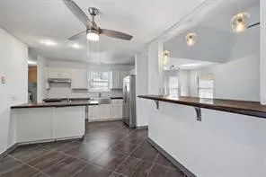 a kitchen with stainless steel appliances a sink cabinets and wooden floor