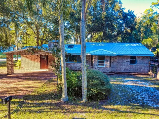 a view of a house with swimming pool next to a yard