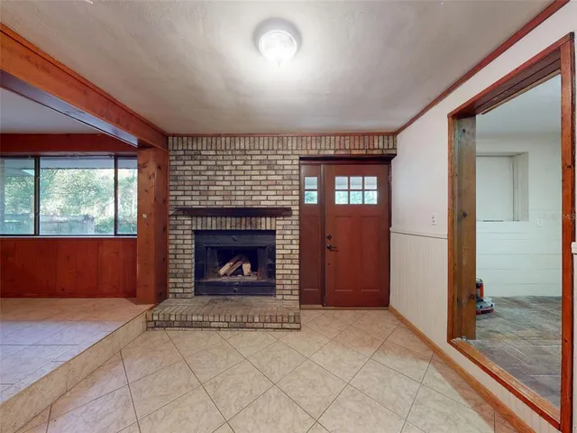 a view of an empty room with a fireplace