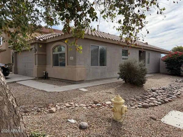 a front view of house with yard and trees around