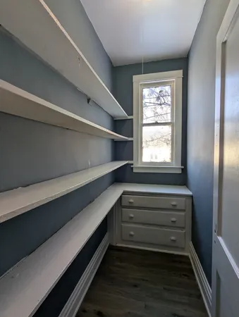 a view of entryway with wooden floor and cabinet