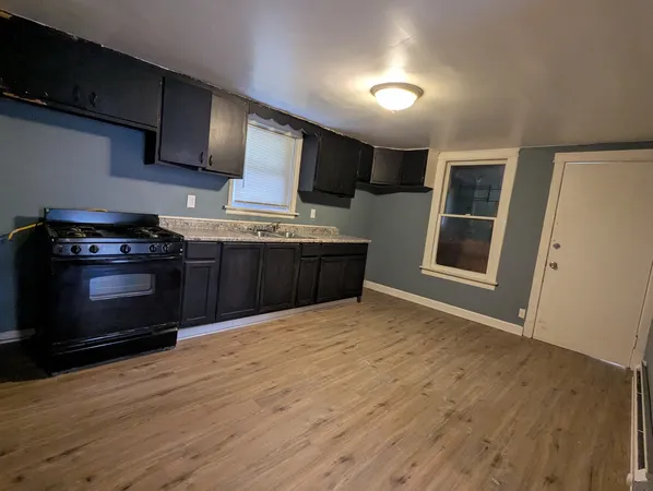 a kitchen with stainless steel appliances granite countertop a stove and a wooden cabinets
