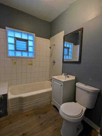 a bathroom with a toilet and a bathtub