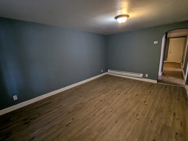 a view of room with wooden floor
