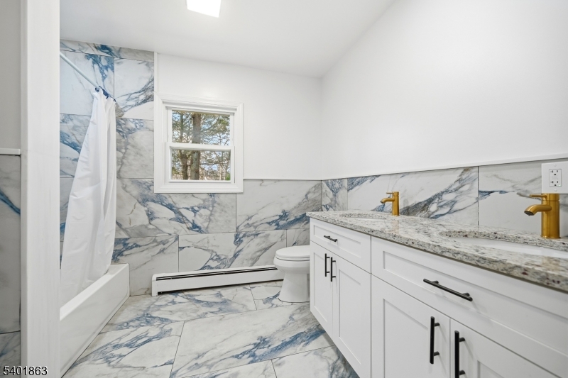 4 Rainbow Trail Vernon, NJ 07422 - Photo 20 of 41 a spacious bathroom with a granite countertop sink and a mirror