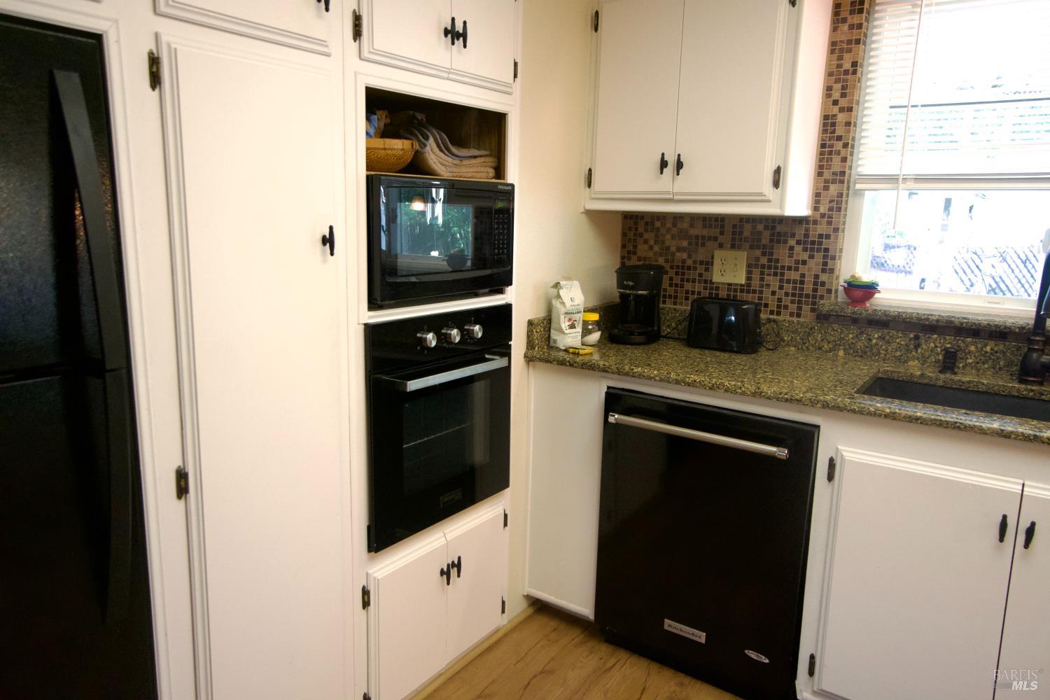 41 Plymouth Way Santa Rosa, CA 95403 - Photo 11 of 28 White kitchen cabinets, granite countertops, microwave, built in oven, dishwasher