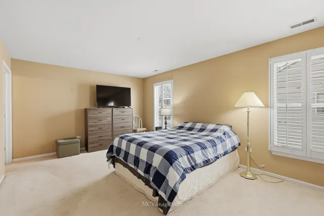 a bedroom with a bed and a mirror