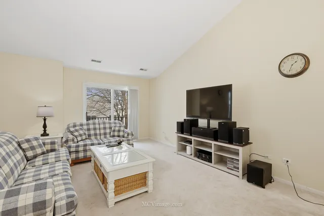 a view of a dining room with furniture and a chandelier