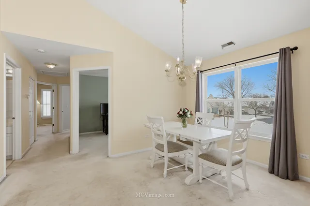a kitchen with white cabinets and appliances