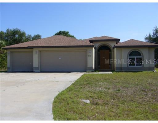 115 Wayne Road Rotonda West, FL 33947 - Photo 1 of 1 a front view of a house with a yard