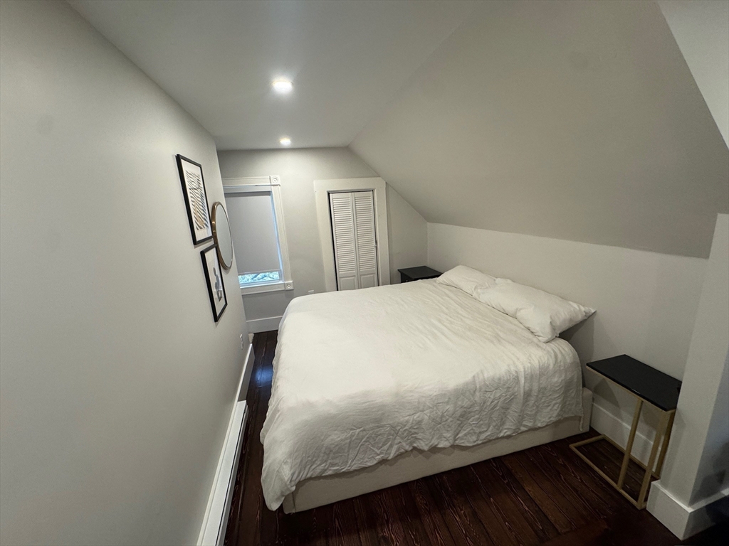 38 Pinckney Street, Unit 3 Somerville, MA 02145 - Photo 20 of 40 a bedroom with a bed a mirror and wooden floor
