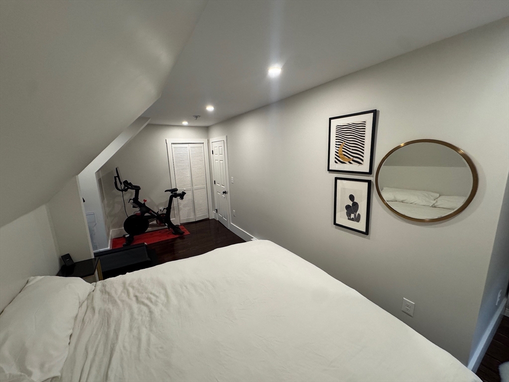 38 Pinckney Street, Unit 3 Somerville, MA 02145 - Photo 21 of 40 a bedroom with a bed and a mirror