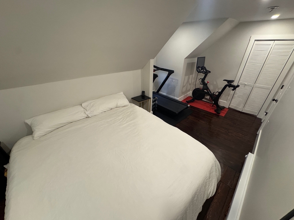 38 Pinckney Street, Unit 3 Somerville, MA 02145 - Photo 22 of 40 a bed sitting in a bedroom and mirror