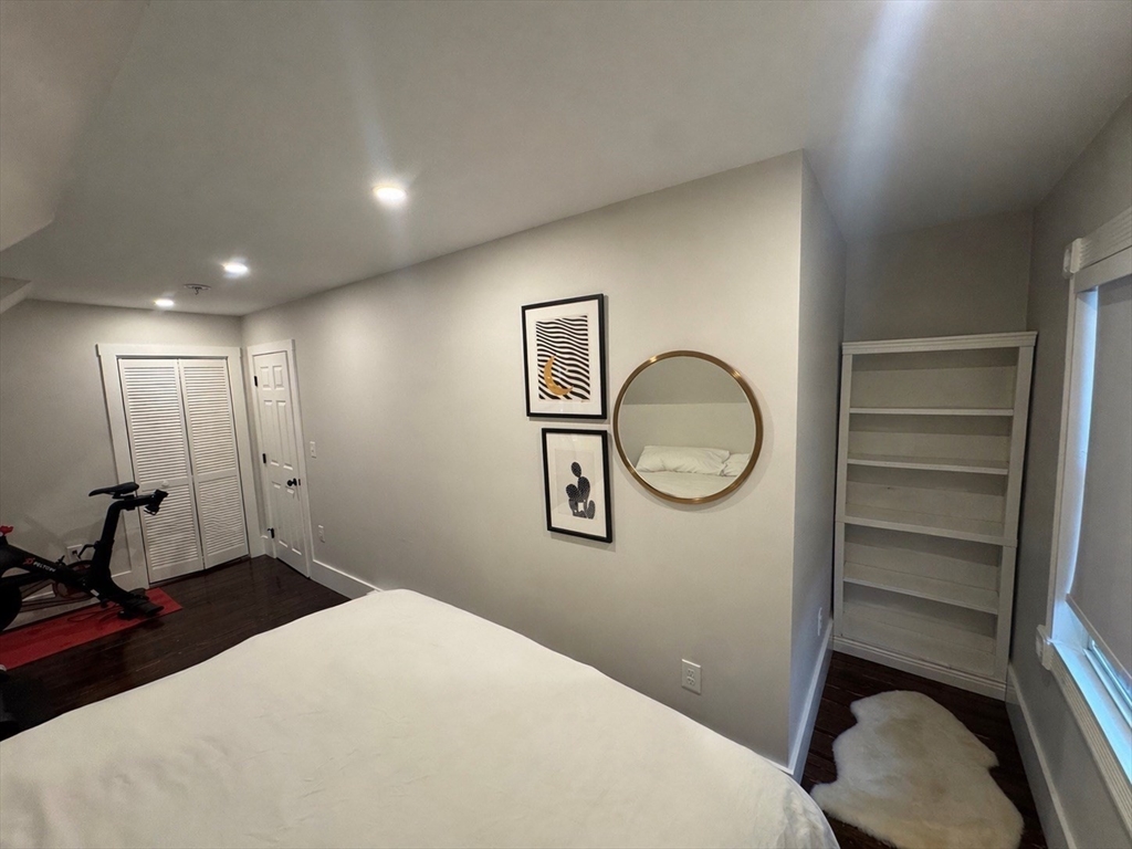 38 Pinckney Street, Unit 3 Somerville, MA 02145 - Photo 23 of 40 a bedroom with a bed and a chandelier