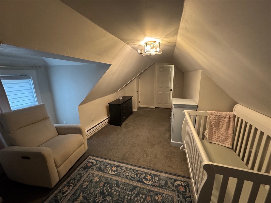 38 Pinckney Street, Unit 3 Somerville, MA 02145 - Photo 26 of 40 a living room with furniture and a rug