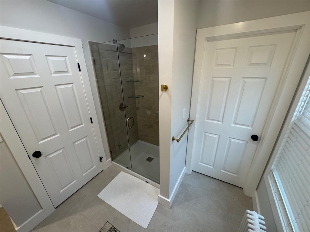 38 Pinckney Street, Unit 3 Somerville, MA 02145 - Photo 31 of 40 a bathroom with a shower and a sink