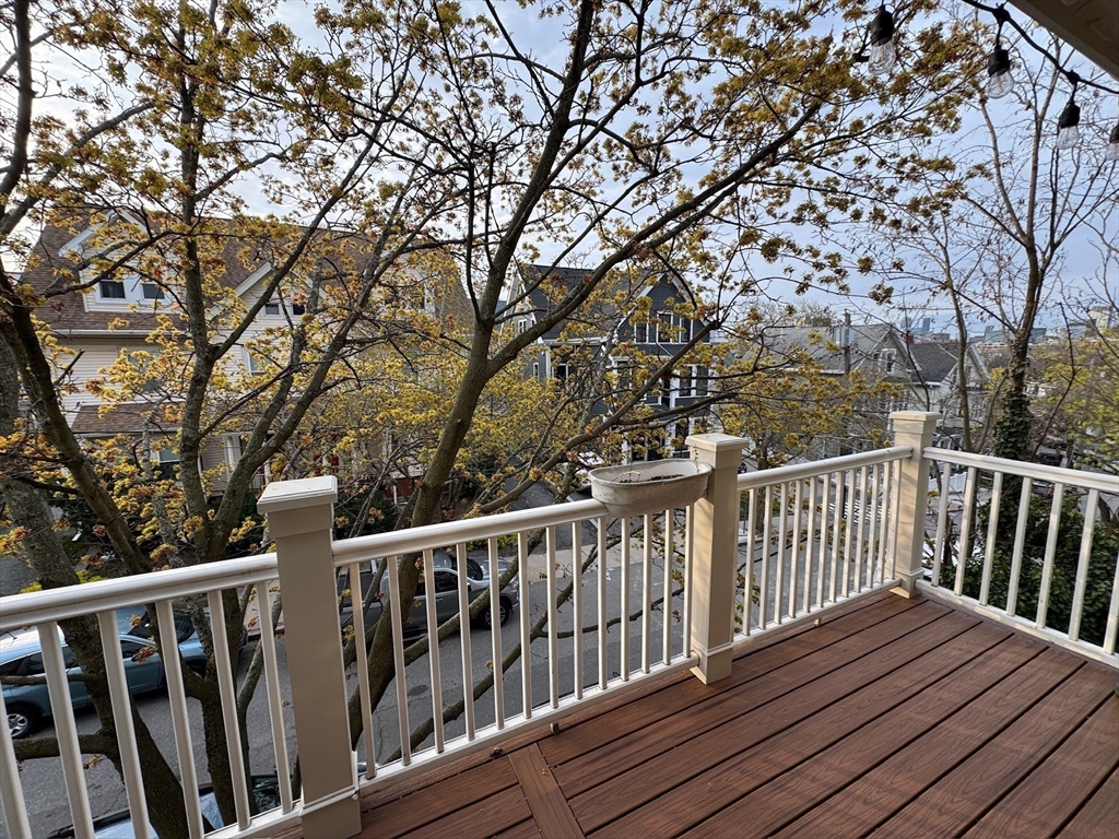 38 Pinckney Street, Unit 3 Somerville, MA 02145 - Photo 32 of 40 a view of balcony with wooden floor and fence